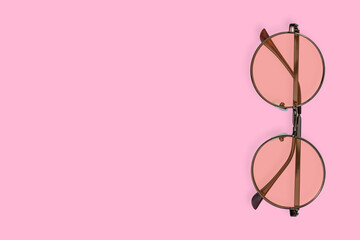 Glasses for improving vision with on a pink background.