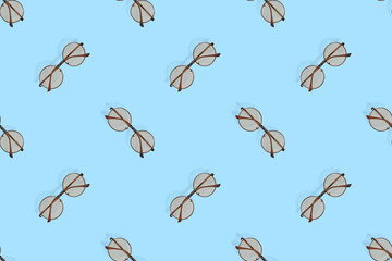 Glasses seamless pattern. Glasses for improving vision on a blue background.