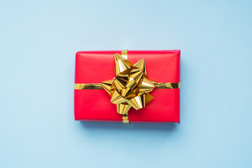 Valentine day composition, Greeting gift box with gold confetti on blue background. Flat lay.