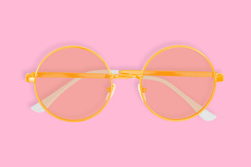 Glasses for improving vision with on a pink background.