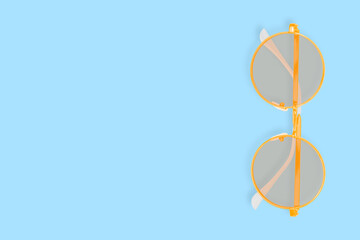 Glasses for improving vision on a blue background.