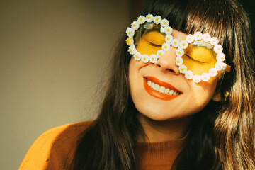 Happy, optimistic and smiling woman with flower sunglasses expresses joie de vivre and positive...