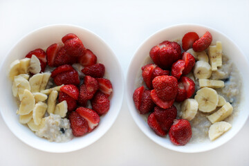 Oatmeal bowl with banana and strawberry, healthy organic food. Image with selective focus