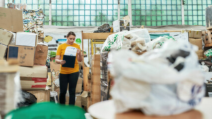 Young woman with papers between litter stacks