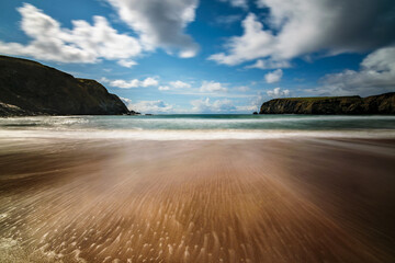 Slow shutter exposure of the Silver Strand, a horse-shoe shaped beach situated at Malin Beg, near Glencolmcille, in south-west County Donegal, Ireland