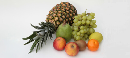 arrangement of different fruits on white background with copy-space