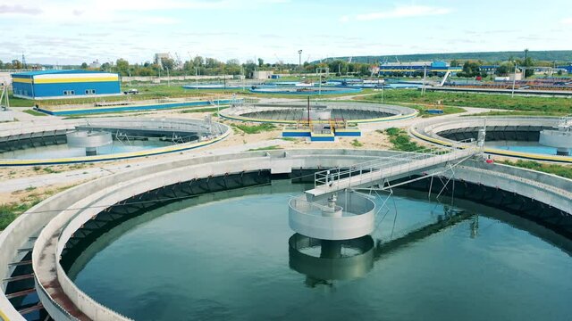 Wastewaters contained in round cleaning reservoirs. Water treatment plant from above.