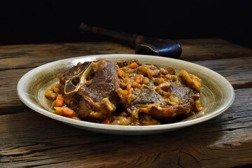 Lamb neck stewed with carrots and onions.
