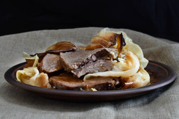 Slices of roasted veal with roasted cabbage