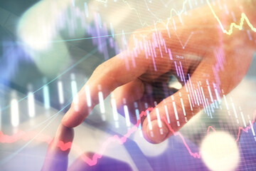 Multi exposure of man's hands holding and using a phone and financial chart drawing. Market analysis concept.