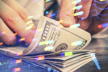 Double exposure of technology drawing hologram and us dollars bills and man hands. Data concept
