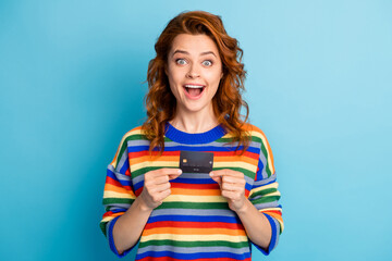 Photo of amazed funny foxy lady dressed striped pullover holding bank card isolated blue color background