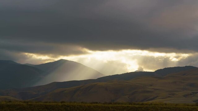 Time lapse of heavenly sun rays peeking through storm clouds in Southern California