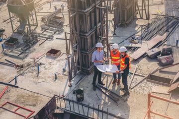 Structural engineer and foreman worker with blueprint discuss, plan working for building...