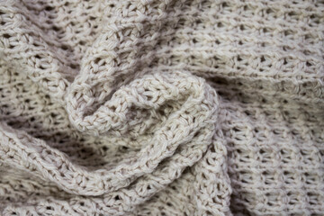 The texture of the knitted woolen thread in close-up.