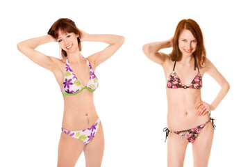 Portraits of two attractive young women wearing colorful bikinis, isolated on white studio background