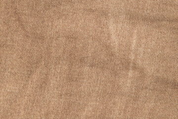 Fototapeta na wymiar fabric grunge background, real cotton denim brown, wrinkled, frayed, close