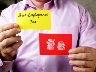Self-Employment Tax phrase on the piece of paper.