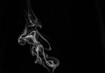 Grey smoke on black background.