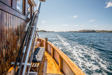 Wooden fishing ship cruising the fjords..