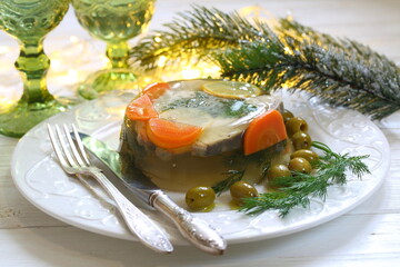 Jellied sturgeon with lemon, olives and glasses of white wine