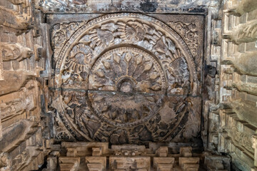 Intricate stone carved artifacts on ceiling of goddess Durga temple in Aihole.