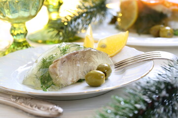 Jellied sturgeon with lemon, olives and glasses of white wine
