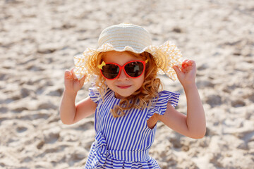 little girl in sunglasses on the beach portrait summer