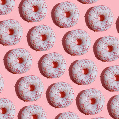 paterna of mouthwatery fresh doughnuts on a pink background