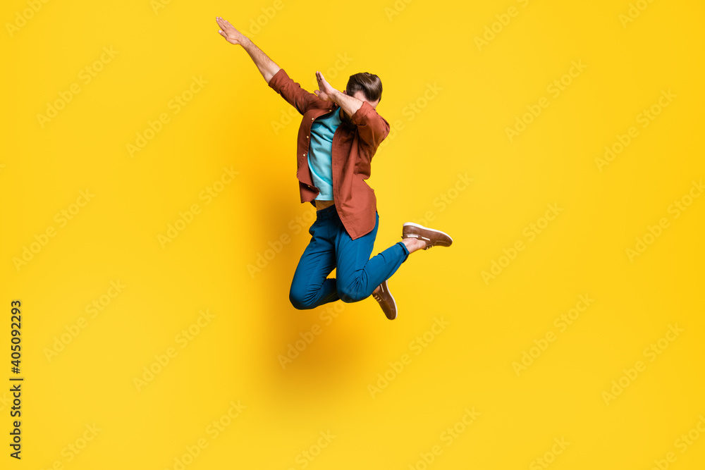 Wall mural Full length body size photo of man showing hype dab sign dancing jumping isolated on bright yellow color background