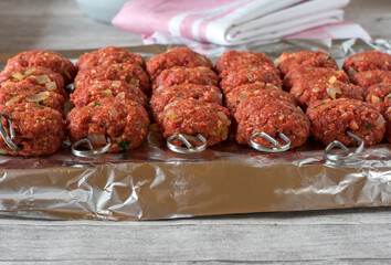raw meatball skewers lined up