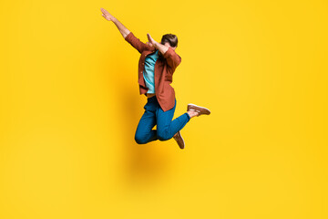 Naklejka na ściany i meble Full length body size photo of man showing hype dab sign dancing jumping isolated on bright yellow color background