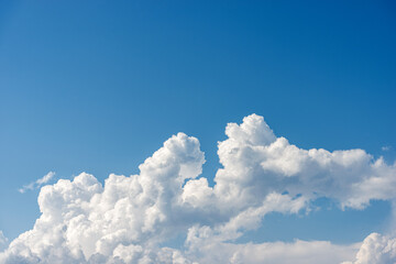 Closeup of a puffy white clouds in a clear blue sky, cumulonimbus. Photography, full frame.