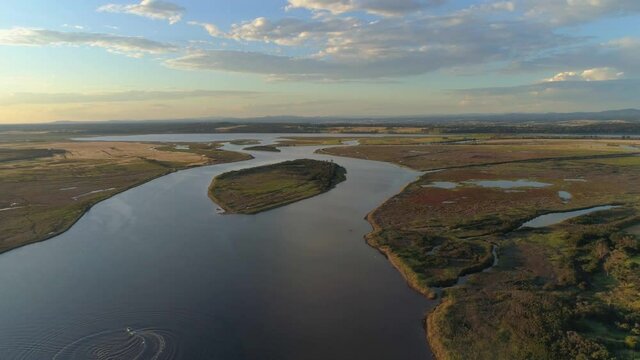Backward flight over Snowy River at sunset in Marlo, Victoria, Australia