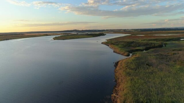 Flight above Snowy River waters at sunset in Marlo, Victoria, Australia