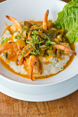Shrimp and Grits. Grits and old bay seasoned jumbo shrimp topped with spices and micro greens. Classic American Diner Style Breakfast or Brunch menu item. Traditional low country southern staple. 