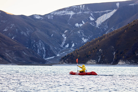 Packraft, one-person light raft used for expedition or adventure racing on a lake, inflatable boat Ride on a mountain lake
