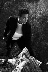 young man in black clothes climbing up the mountain