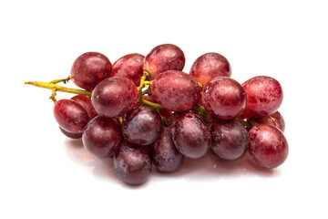 Real and unedited texture of red grapes in isolated white background with their shadow.