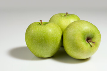 Three green ripe juicy apples.