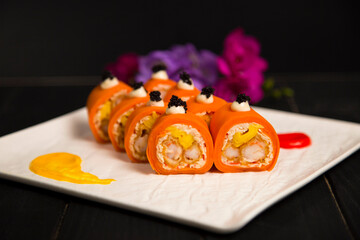 Side view of healthy Japanese no rice sushi roll with tempura black tiger shrimp (prawn) wrapped in...