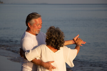 Senior couple dancing on beach.elderly travel leisure and activity after retirement in vacations and summer