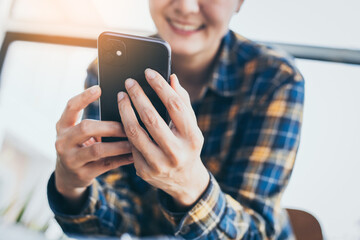 man work using cell phone hand holding mobile texting message contact us.chatting,search internet information in office.technology device communication connecting