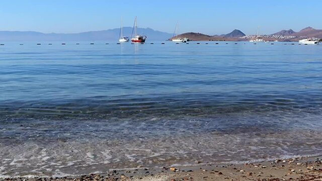 Beautiful calm blue bay with sand beach in Mediterranean. Holiday and relaxation on sea coast