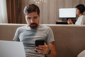 Couple Working And Playing With Laptop Computer At Home