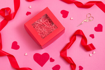 Top view of Gift box packing on pink color table. Valentines day decor ribbons and hearts