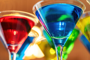 Variation alcoholic drinks served on bar counter. Colored drinks in glasses.