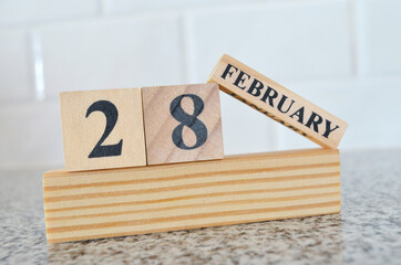 February 28, Cover design with number cube on a white background and granite table.