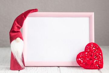 Valentines day gnome with red heart and a pink frame mockup on the light background, copy space