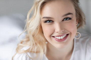 Portrait of a happy young woman at home